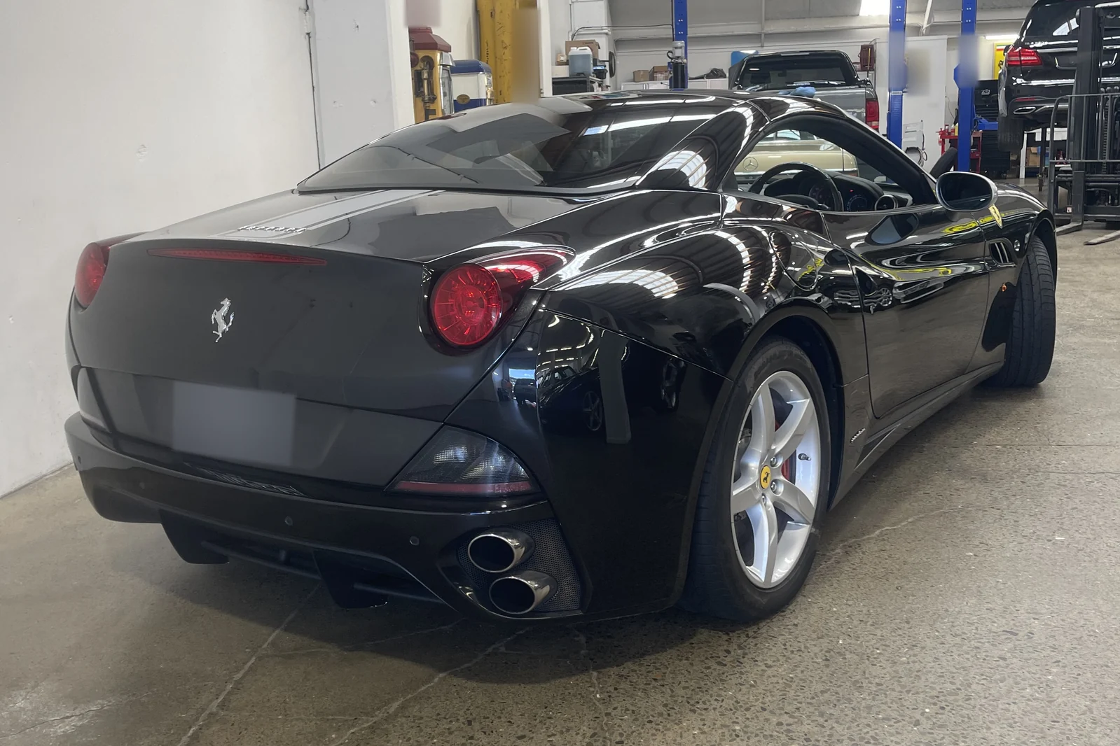 Black Ferrari showing its polished rear and side